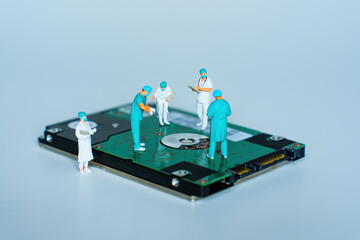 Miniature Surgeons Performing Data Surgery on Hard Drive