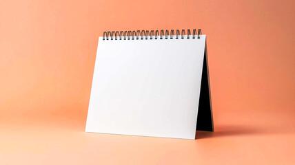 Blank white desk calendar mockup isolated on peach background