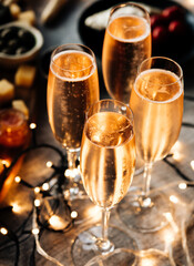 Glasses of sparkling wine or champagne served on the table for Christmas or New Year eve celebration.