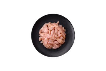 Raw chicken fillet cut into strips with spices and herbs