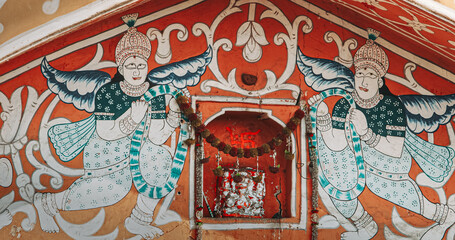 Close-up View On Old-painted Walls. Frescoes On Once Of Fortress Gates In Jaipur. Religious Motifs Of Hinduism. Architecture Of Jaipur Or Pink City Due To Dominant Color Scheme Of Its Buildings In Old