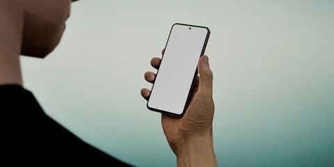 Caucasian White male using smartphone with a blank white screen. Abstract, blurred, gradient apps mockup. Vertical phone orientation