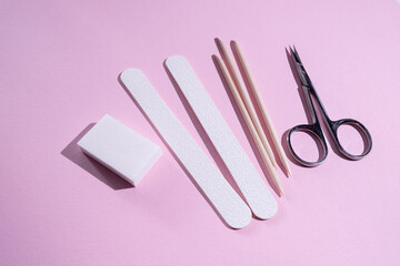 Manicure and pedicure tools composition, flat lay. Nail polish, file, scissors. Professional nail care equipment. Beauty care concept