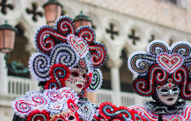 wonderful colorful costumes roam around St. Mark's Square in Venice for Carnival