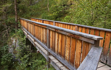 Fototapeta premium Wooden footbridge on hiking track in Wolfsklamm at Stans, Austria, Europe 