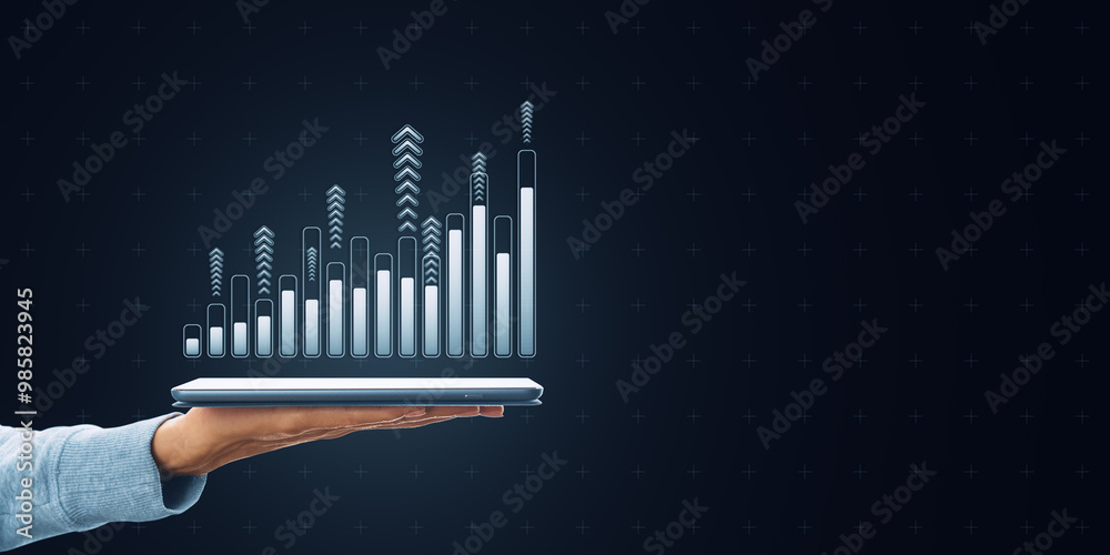 Poster hand holding a tablet with a holographic bar chart displaying upward trends on a dark digital backgr