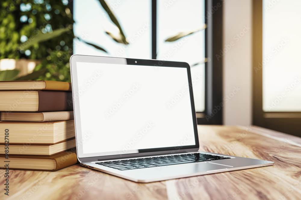 Poster laptop with blank screen beside stacked books on wooden table in library. 3d rendering
