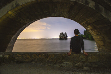 Erhai Lake, Dali, Yunnan - Rear view of a person sitting on an arch