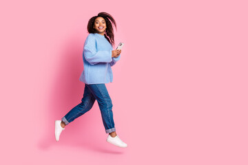 Full size profile photo of pretty young woman jump run empty space isolated on pink color background