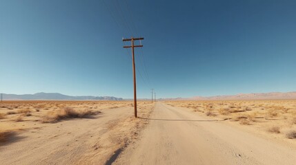 A single power pole stands tall amidst the vast and desolate landscape of the Mojave Desert, a testament to the human presence in this harsh environment. The dry, sandy ground stretches out in all dir