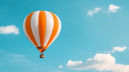 Fototapeta premium A vibrant orange and white hot air balloon floats gracefully against a backdrop of a clear blue sky. The balloon represents freedom, adventure, and a sense of wonder, while the clouds symbolize hope a