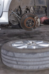 Tire replacement. Disc brake of the vehicle for repair, in process
