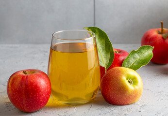 Apple juice in the glass with apples