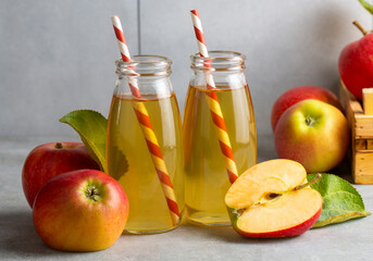 Apple juice in the glass with apples