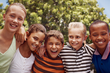 Obraz premium Children, hugging and smile of student friends outdoor at school together for development. Diversity, scholarship or smile with boy and girl kids embracing on playground for learning or study