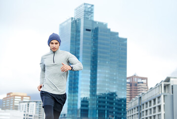 Fitness, running and portrait of man in city for cardio jog, race or training for healthy body in Mexico. Sports, exercise and runner outdoor in urban town for wellness, marathon or workout in winter