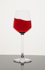 Red wine in a glass with splash isolated on white background 1
