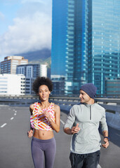 Fototapeta premium City, portrait and couple with running for fitness, endurance and health benefits with training on road. Bridge, man and woman with support for cardiovascular exercise, burn calories and wellness