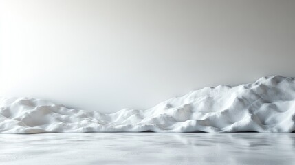 Gentle snow mounds create a peaceful winter panorama under a soft, overcast sky