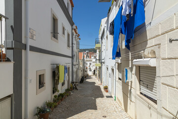 An alley with white houses in Sesimbra Portugal