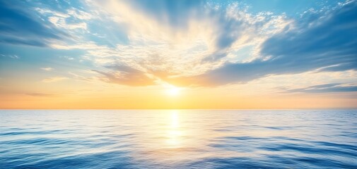 Fototapeta premium Breathtaking view of the sun setting over calm ocean waters, with vibrant colors and dramatic clouds reflecting on the surface.