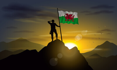 Wales flag, silhouette of man holding flag on Sunset cliff. Vector Illustrator