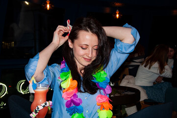 Girl in Hawaii restaurant. Aloha. Party woman in bar or restaurant. Birthday party girl. Cocktail...