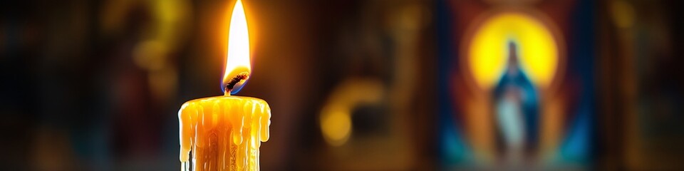 A single candle, lit in front of an icon of the revered Saint Mary and Theotokos, concept of orthodox holidays, prayer, religious sacrament, God's help, prayer to the Virgin Mary © Elena