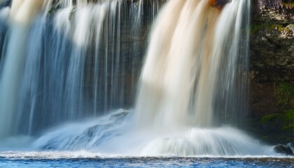 Obraz premium Keila waterfall texture, Estonia. Close-up, long exposure. Blue and white water splashes. Abstract natural pattern. Environmental conservation, travel destinations, graphic resource. Panoramic image