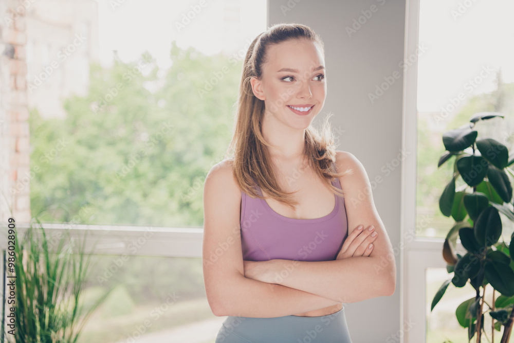 Sticker Photo of lovely sporty active girl wearing sportswear training at home gym indoors