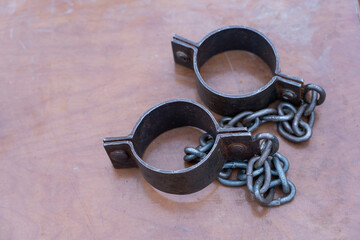 Ancient iron shackles of a slave with a chain