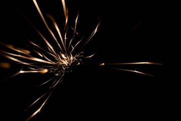 sparks from the grinder glowing in the dark
