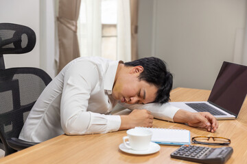 Man with narcolepsy is fall asleep on office desk..Narcolepsy is a sleep disorder that makes people very drowsy during the day.