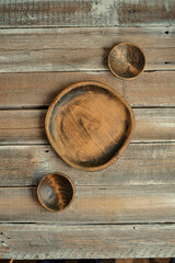 Natural wooden bowls arranged on a rustic wooden table highlighting artisanal craftsmanship