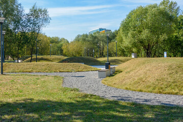 Eco-path made of gravel among artificial hills and lanterns.