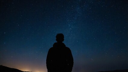 A starry night sky with a silhouette of a person gazin