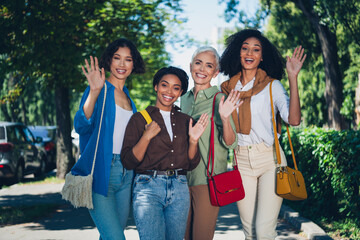 Portrait of group friends women arms wave hello pastime weekend walk city center park outdoors