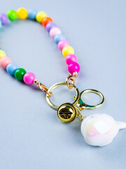 funny white whale keychain with beads on desk