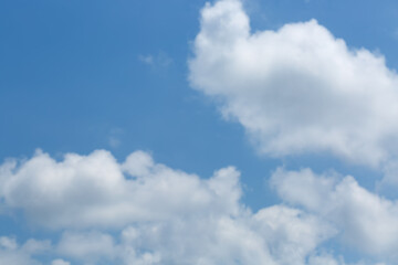 Blue sky with scattered fluffy white clouds. The clouds vary in size and shape, some are denser and more defined while others are wispy and spread out. Backdrop to the soft white cloud. Beauty nature