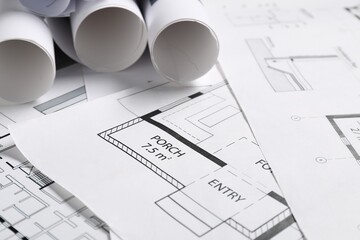 Different architectural drawings on table, closeup view