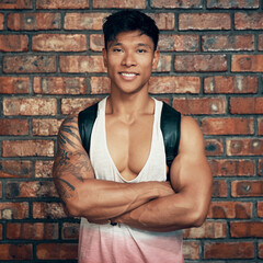 Portrait, brick wall and Asian man with fitness, arms crossed and training with wellness. Face, healthy person and bodybuilder with confidence, pride and exercise with workout, bulking and challenge