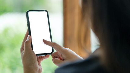 Close up shot of hands holding a smartphone with a blank screen,  for mockup designs or app interface demonstrations.