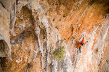 A rock climber ascends to the summit via a difficult route.