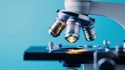 A close-up of a microscope lens with a blue background.