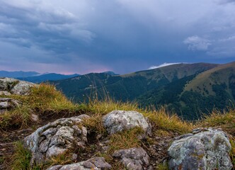 Mountain landscape after a storm. Autumn meadows, forested and rocky hills of fog, rain and clouds. Morning wading in the mountains, the beauty of mountain hiking.
