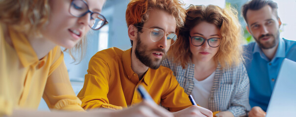 Young professionals collaborating on creative project in modern office