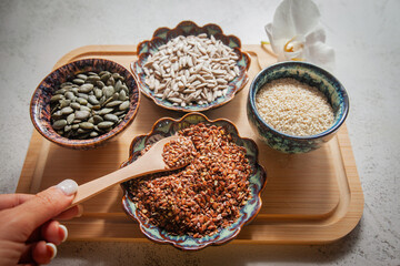 Seed cycling for hormonal balance - flax, pumpkin, sunflower and sesame seeds for different phases of menstrual cycle, women's health