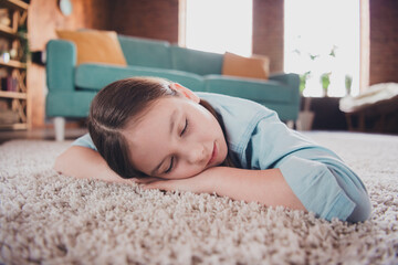 Portrait of cute little girl sleep comfy carpet floor wear shirt loft interior modern flat indoors