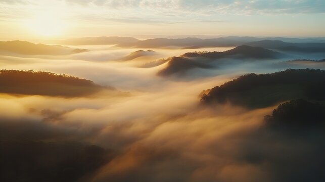 A breathtaking sunrise over misty hills, creating a serene and mystical landscape bathed in golden light.