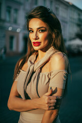 Beautiful girl in a dress and a red retro beret, a brunette sitting on a bench in the city, fashion portrait, makeup, autumn mood, smile, full-length portrait, Paris, red lips, old town